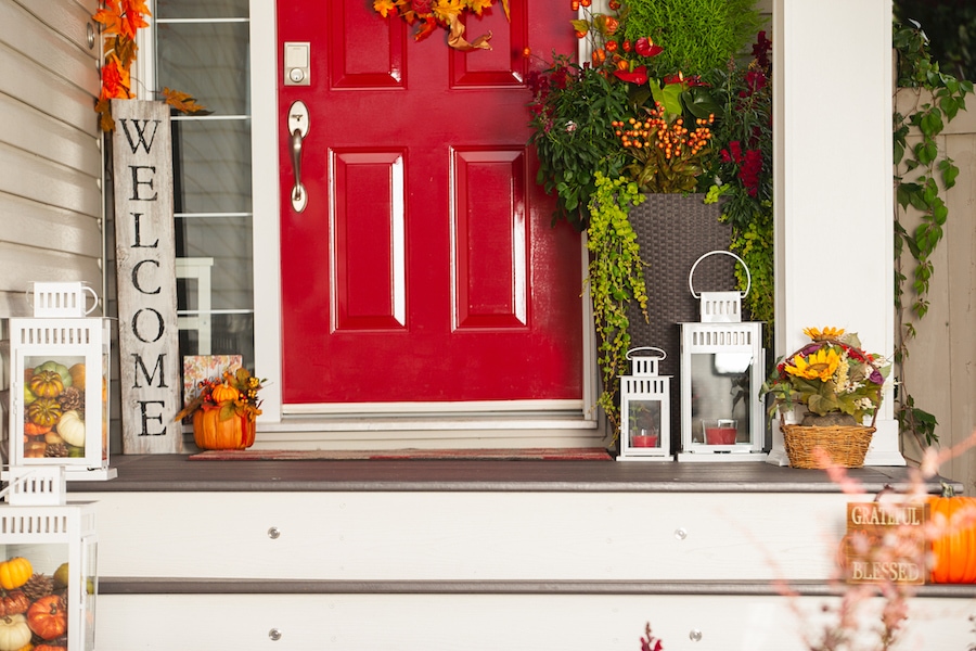 Festive autumn porch outside of home decorated after homeowner scheduled their fall HVAC Maintenance