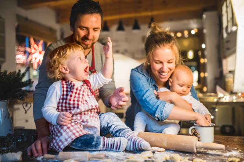 6 ways your furnace keeps you safe, a happy family of four bake together in their home