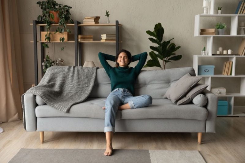 Image of someone sitting back on a couch. How a Whole-House Humidifier Keeps You Healthy.